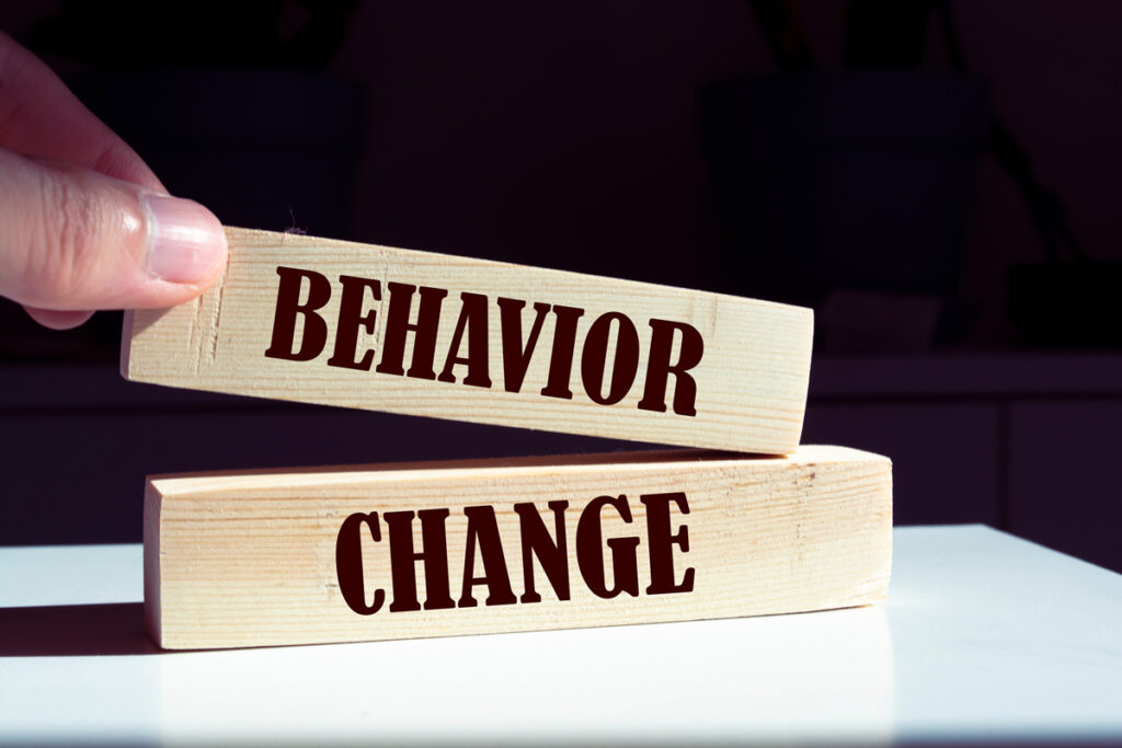 change and behaviour written on wooden blocks