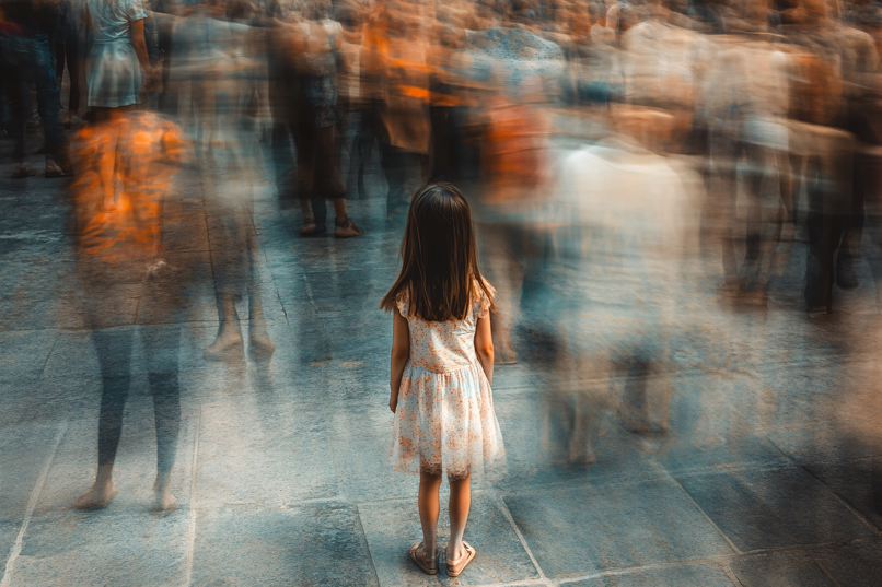 A child lost in a blurry crowd